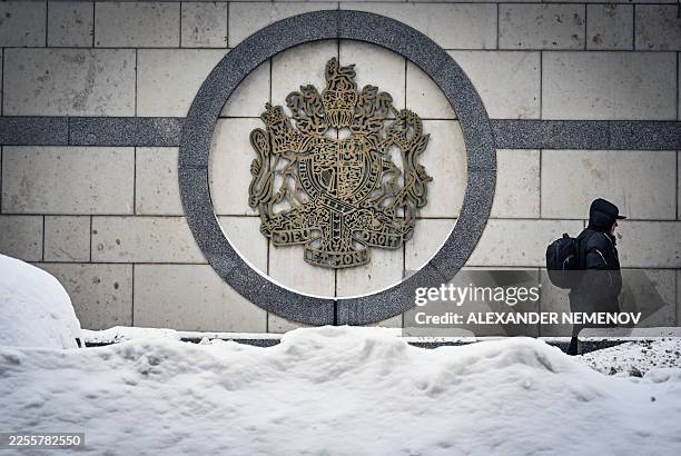 Person walks past the British embassy building in Moscow on January 15, 2026. Russia said on January 15, 2026 it was expelling a British diplomat,...
