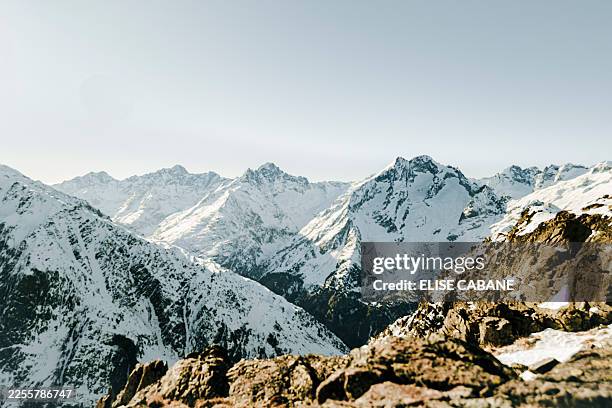 Panoramic shot of a landscape taken at 3200 meters altitude during a snowshoe hiking with in the foreground bare rock and in the background a...