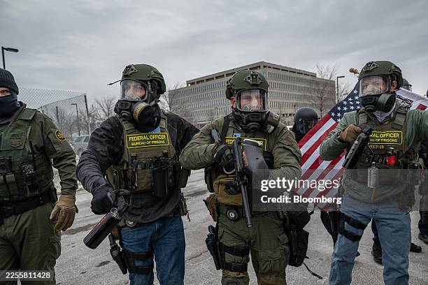 Federal law enforcement officers attempt to disperse demonstrators protesting Immigration and Customs Enforcement activity outside the Bishop Henry...