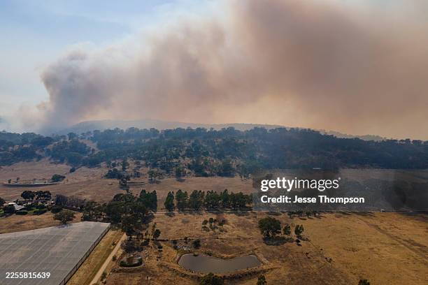 Bushfires continue to burn in the hills on January 12, 2026 in Harcourt, Australia. Bushfires have burned tens of thousands of hectares in central...
