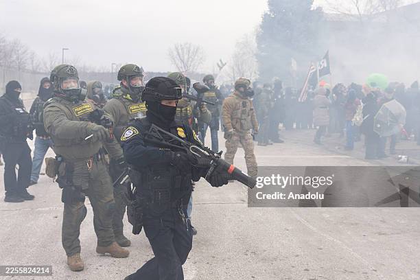Federal agents clash with protestors outside an Immigration and Customs Enforcement facility in Minneapolis, Minnesota, during a demonstration over...