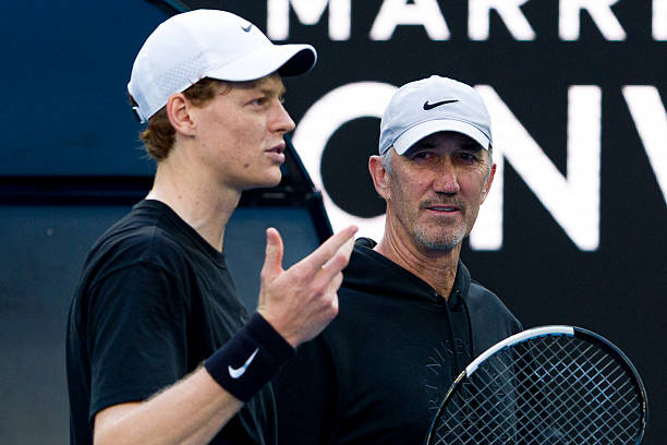 Jannik Sinner of Italy reacts with coach Darren Cahill during a practice session ahead of the 2026 Australian Open at Melbourne Park on January 12,...