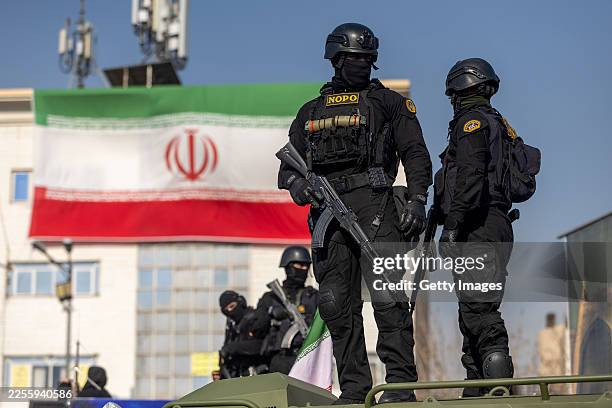 Security forces are seen during a pro-government rally on January 12, 2026 in Tehran, Iran. Tens of thousands of demonstrators gathered in Tehran's...