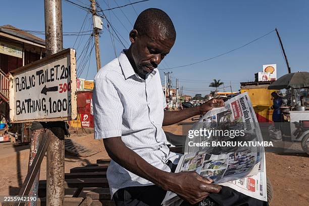 Resident reads a newspaper showing articles about the elections on a street in Kampala, Uganda, on January 16, 2026 a day after the 2026 Ugandan...
