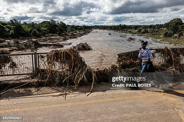 Young girl walks across the damaged bridge crossing the Ga-Selati River, just outside Phalaborwa on January 16, 2026 following heavy rains over much...