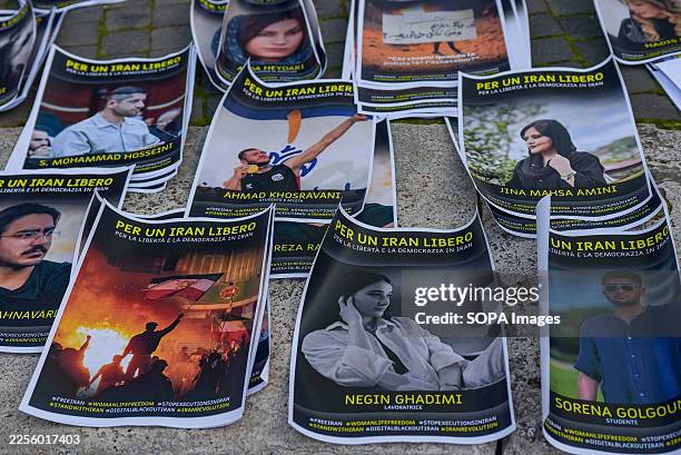 Photos of Iranian victims of government repression are displayed during a demonstration organized by Amnesty International and Woman Life Freedom for...