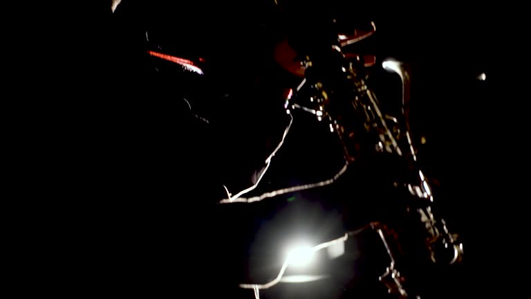 https://media.gettyimages.com/id/2256074244/video/saxophonist-illuminated-by-dramatic-backlighting-close-up-video-cinematic-lighting-close-up.jpg?b=1&s=640x640&k=20&c=XBNKqu2_V_dI1CnvXEkXtdVRdepMHuHpQbRldpL1HOA=