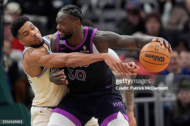 Giannis Antetokounmpo of the Milwaukee Bucks defends against Julius Randle of the Minnesota Timberwolves during the fourth quarter at Fiserv Forum on...
