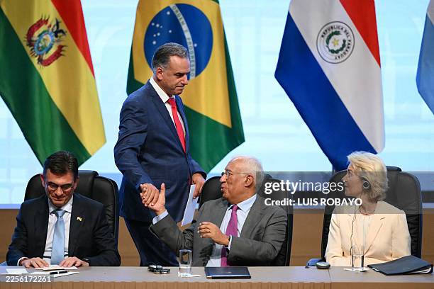 Uruguay's President Yamandu Orsi and President of the European Council Antonio Costa shake hands during the signing ceremony of the trade agreement...