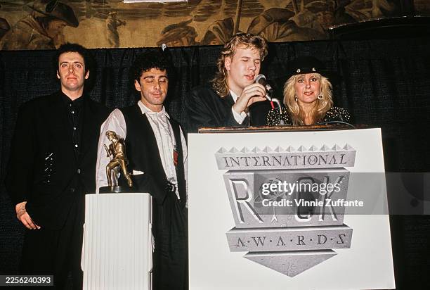 Canadian singer, songwriter and guitarist Jeff Healey, wearing a black suit with a bolo tie, and American singer, songwriter and guitarist Lita Ford,...