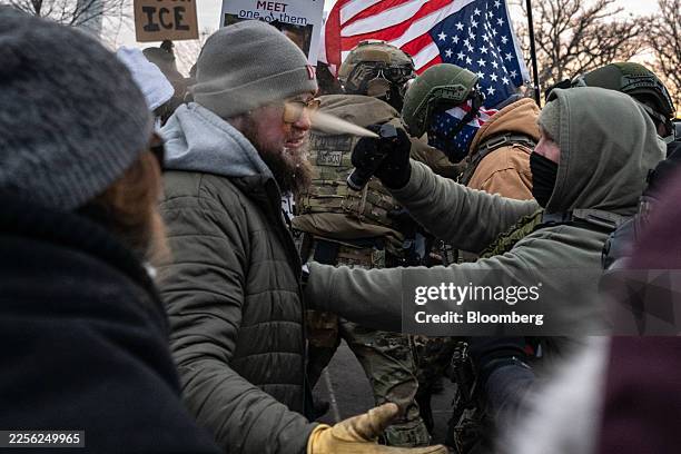 Federal law enforcement officers use pepper spray against a demonstrator during a protest outside the Bishop Henry Whipple Federal Building in St....