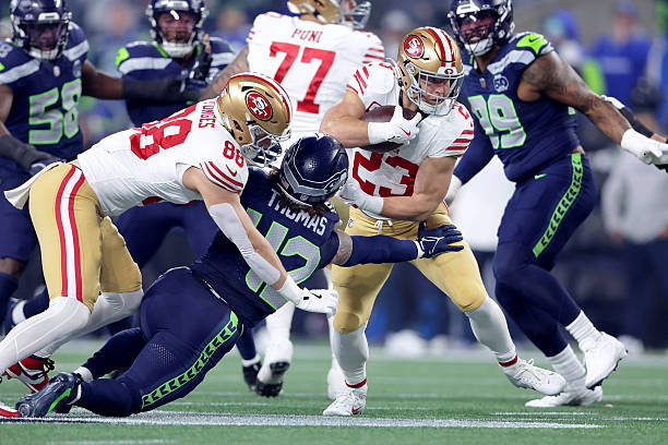 San Francisco 49ers Christian McCaffrey gets tackled by Seattle Seahawks Drake Thomas during the first quarter of the NFC Divisional Round playoff...