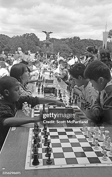 View of children playing chess during the 9th annual 'Chess in the Parks' tournament on the Bethesda Terrace in Central Park, New York, New York,...