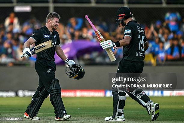 New Zealand's Glenn Phillips celebrates with his teammate Daryl Mitchell after scoring a century during the third one-day international cricket match...