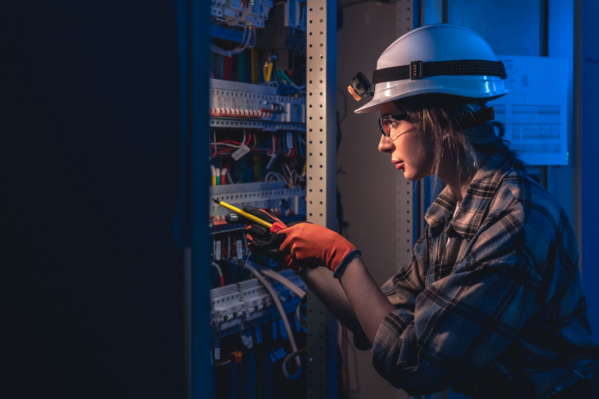 electrician inspecting panel
