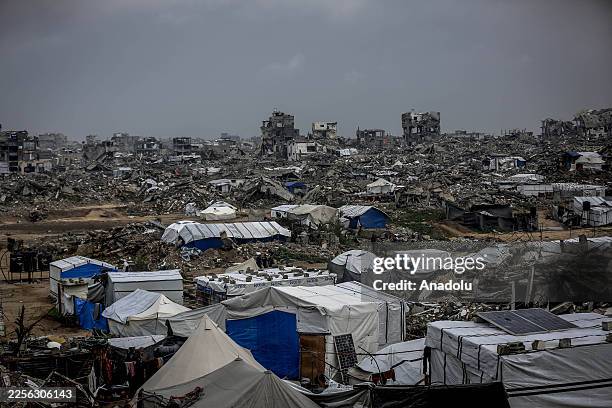Displaced Palestinians, deprived of basic necessities, struggle to maintain their daily lives amid the rubble left behind by Israeli attacks as they...