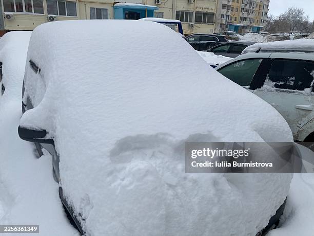cars covered in thick snow in a parking lot on a cold winter day - snow plow fleet stock pictures, royalty-free photos & images