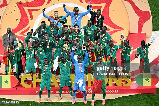 Senegal players celebrate with the trophy after winning the Africa Cup of Nations final football match against Morocco at the Prince Moulay Abdellah...