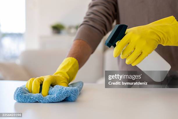home surface cleaning with yellow gloves - pathogen stock pictures, royalty-free photos & images