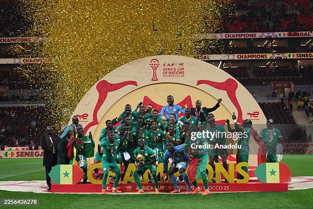 Senegalese players raise the trophy after winning the 35th Africa Cup of Nations final match against Morocco at the Prince Moulay Abdellah Stadium in...