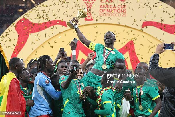 Senegalese players raise the trophy after winning the 35th Africa Cup of Nations final match against Morocco at the Prince Moulay Abdellah Stadium in...