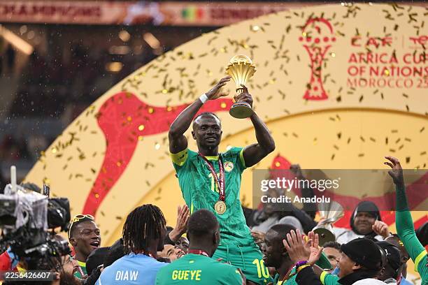 Senegalese players raise the trophy after winning the 35th Africa Cup of Nations final match against Morocco at the Prince Moulay Abdellah Stadium in...
