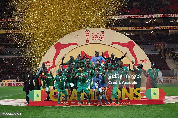Senegalese players raise the trophy after winning the 35th Africa Cup of Nations final match against Morocco at the Prince Moulay Abdellah Stadium in...