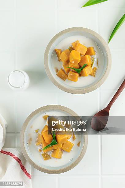 kolak labu or sweet pumpkin coconut soup, popular for ramadan takjil in indonesia - coconut milk stock pictures, royalty-free photos & images