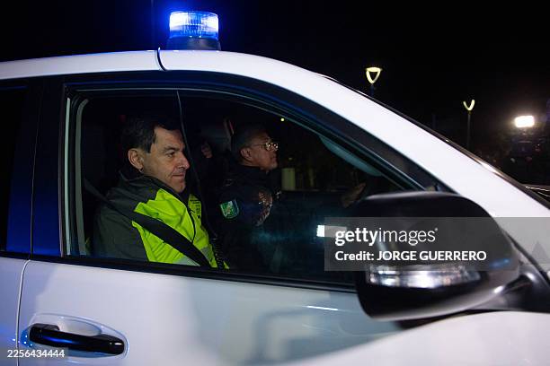 President of the Junta de Andalucia Juanma Moreno Bonilla rides in a police car to the site of a train accident in Adamuz, southern Spain, early on...