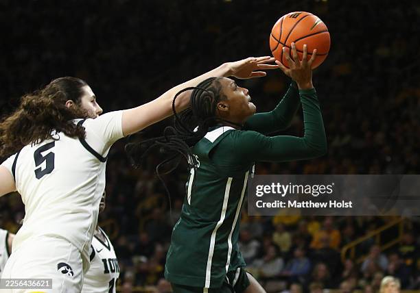 Guard Rashunda Jones of the Michigan State Spartans goes to the basket in the first half against center Ava Heiden of the Iowa Hawkeyes on January...