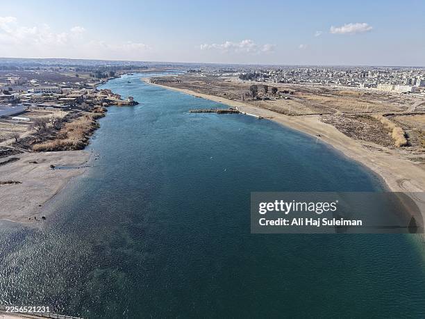 An overview shows a section of the Euphrates River on January 19, 2026 in Raqqa, Syria. Yesterday, the Syrian government announced that a nationwide...