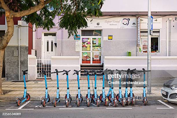 parking area for electric scooters - trotinete imagens e fotografias de stock
