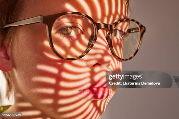 child with glasses featuring abstract shadow pattern - optical illusion face stock pictures, royalty-free photos & images