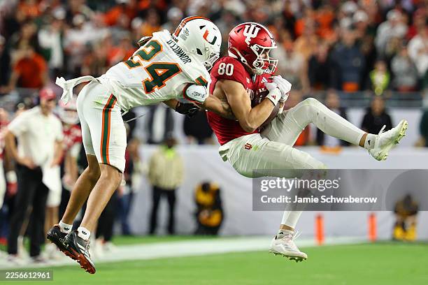 Charlie Becker of the Indiana Hoosiers makes a contested catch against Ethan O'Connor of the Miami Hurricanes during the fourth quarter in the 2026...