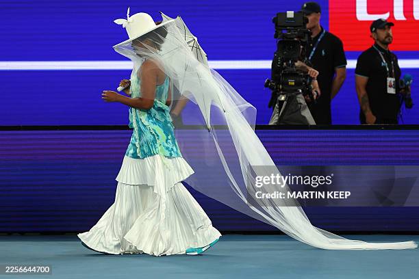 Japan's Naomi Osaka arrives wearing a Robert Wun designed outfit to face Croatia's Antonia Ruzic during their women's singles match on day three of...