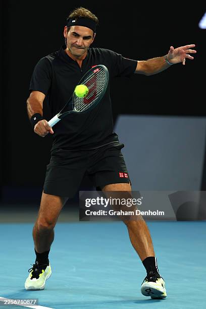 Roger Federer of Switzerland plays a backhand during the Opening Ceremony exhibition match ahead of the 2026 Australian Open at Melbourne Park on...