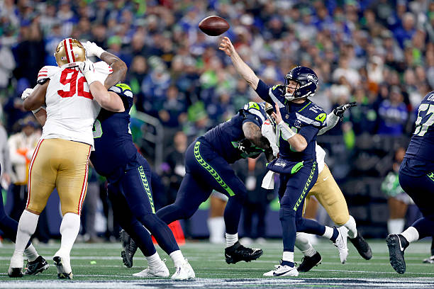 Sam Darnold of the Seattle Seahawks throws a pass during the first quarter against the San Francisco 49ers in the NFC Divisional Playoff game at...