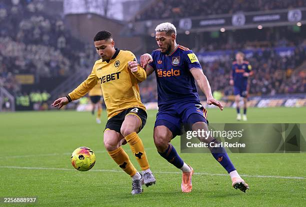 Joao Gomes of Wolverhampton Wanderers is challenged by Joelinton of Newcastle United during the Premier League match between Wolverhampton Wanderers...