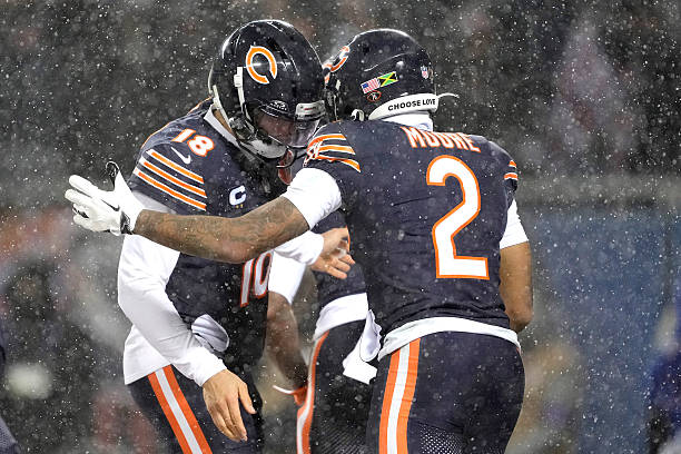 Moore of the Chicago Bears celebrates his touchdown reception against the Los Angeles Rams with Caleb Williams during the second quarter in the NFC...