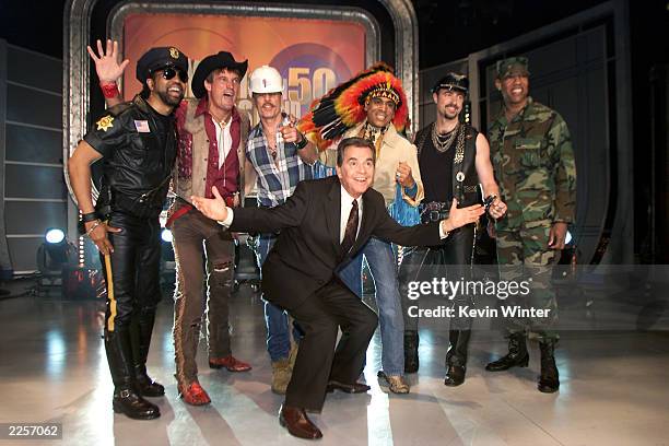 Host Dick Clark with a non-original line-up of disco group Village People, at the taping of "American Bandstands 50th...A Celebration" television...