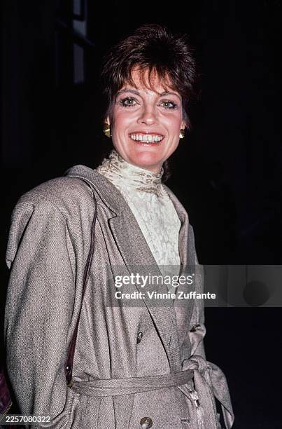American actress Linda Gray wearing a grey double-breasted coat, United States, circa 1982.