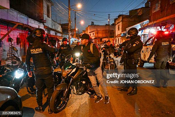 Guatemalan police officers set up a checkpoint on a street in the Gallito neighborhood during the state of emergency declared by the government in...