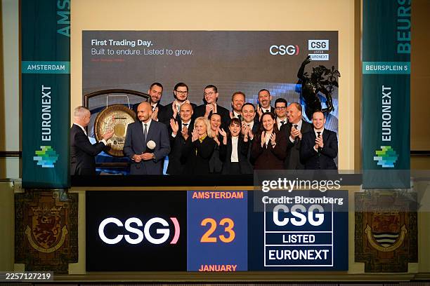 Rene van Vlerken, chief executive officer of Euronext Amsterdam, left, and Michal Strnad, chairman of CSG NV, second left, during the listing of CSG...