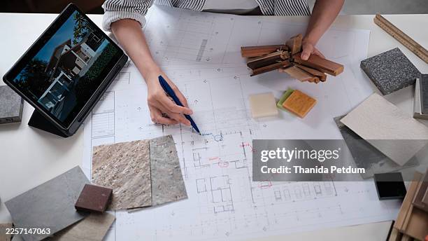 architect's hands check and marks on drawing paper in design studio. - construction material inspection stock pictures, royalty-free photos & images