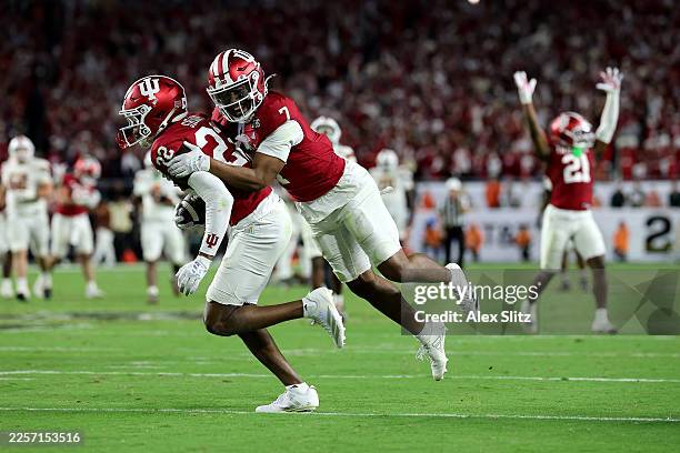 Jamari Sharpe and Louis Moore of the Indiana Hoosiers celebrate after Sharpe intercepted a pass to seal the game against the Miami Hurricanes during...