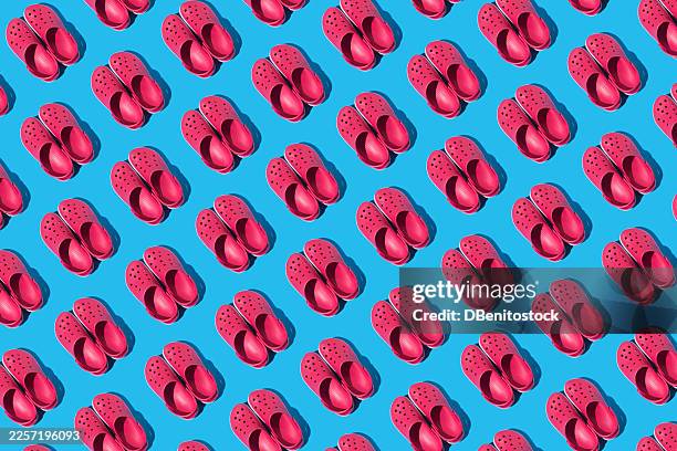 pattern of red foam clogs on a blue background. concept of summer, footwear, sole, comfort, slippers, rest, ergonomic, plantar fasciitis, feet and rubber. - plantar fasciitis stock pictures, royalty-free photos & images