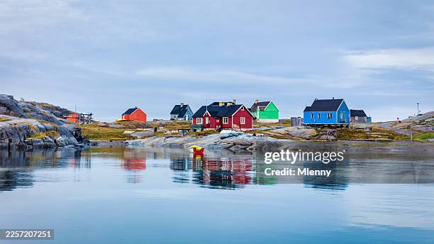 colorful houses reflected in calm water ilulissat greenland - ilulissat stock pictures, royalty-free photos & images