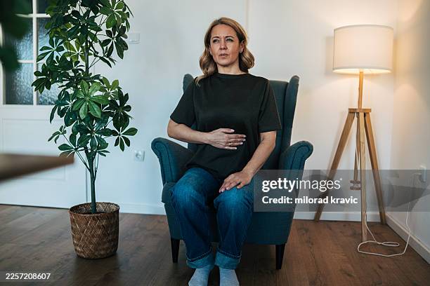 woman experiencing abdominal pain, stomach ache, indigestion - gastroenterology stock pictures, royalty-free photos & images