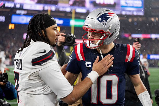 Drake Maye of the New England Patriots and C.J. Stroud of the Houston Texans share a moment following an NFC Divisional Playoff game at Gillette...