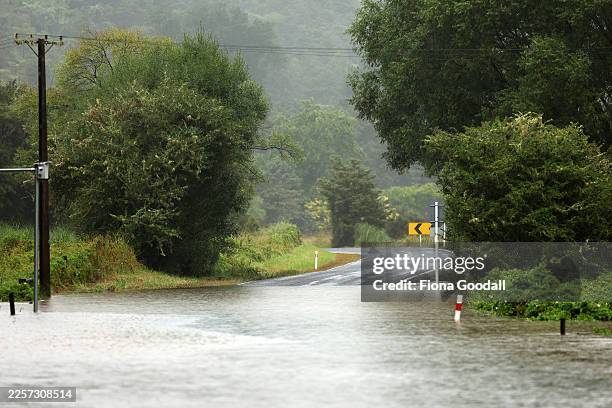 Flooded road in Kaipara Flats on January 21, 2026 in Auckland, New Zealand. Heavy rain and severe gales are lashing New Zealand's North Island, with...